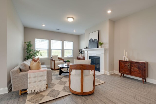 1207 Bridgett Way, Mount Juliet, TN 37122 - living room featuring light wood-style flooring, a glass covered fireplace, baseboards, and recessed lighting