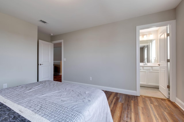 1207 Bridgett Way, Mount Juliet, TN 37122 - bedroom with wood finished floors, baseboards, and connected bathroom