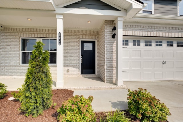 1207 Bridgett Way, Mount Juliet, TN 37122 - doorway to property with brick siding, a porch, and a garage
