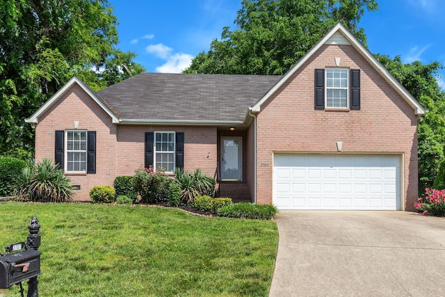 2707 Comer Dr, Murfreesboro, TN 37128 - view of front of house with brick siding, driveway, a front yard, and an attached garage