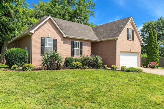 2707 Comer Dr, Murfreesboro, TN 37128 - view of front of property with brick siding, driveway, a front lawn, a garage, and roof with shingles