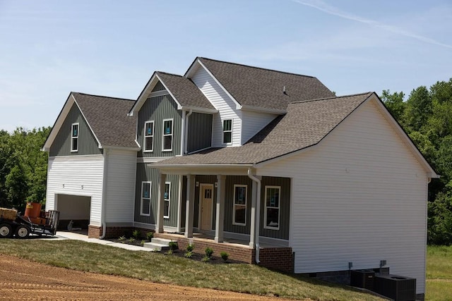 5590 Chambers Rd, Cumberland Furnace, TN 37051 - modern farmhouse featuring covered porch, a shingled roof, a front yard, and cooling unit