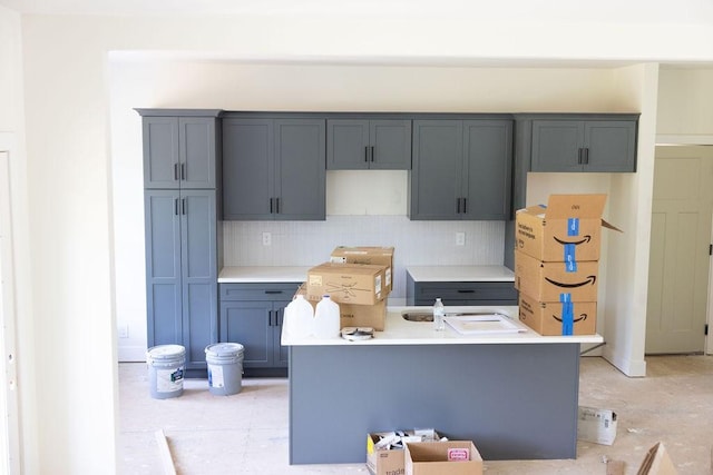 5580 Chambers Rd, Cumberland Furnace, TN 37051 - kitchen with tasteful backsplash, an island with sink, light countertops, and gray cabinets