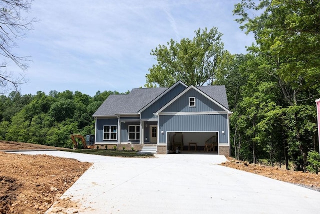 5570 Chambers Rd, Cumberland Furnace, TN 37051 - craftsman house featuring driveway, a porch, a garage, and roof with shingles