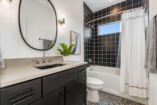 600B 41st Ave N, Nashville, TN 37209 - full bathroom featuring toilet, vanity, shower / bath combo with shower curtain, and speckled floor