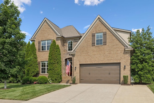 4181 Miles Johnson Pkwy, Spring Hill, TN 37174 - traditional-style house with concrete driveway, brick siding, an attached garage, and a front yard