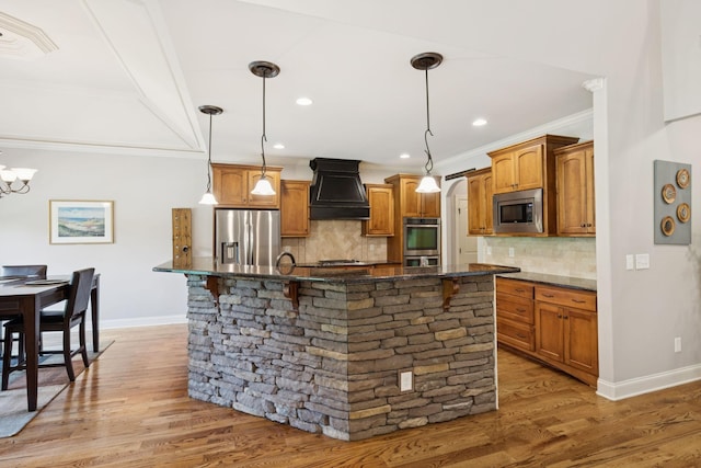 4181 Miles Johnson Pkwy, Spring Hill, TN 37174 - kitchen featuring appliances with stainless steel finishes, premium range hood, crown molding, baseboards, and backsplash