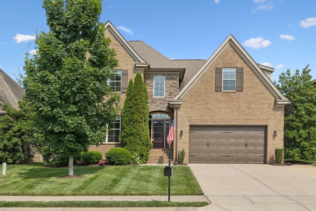 4181 Miles Johnson Pkwy, Spring Hill, TN 37174 - traditional-style house with brick siding, concrete driveway, an attached garage, and a front lawn