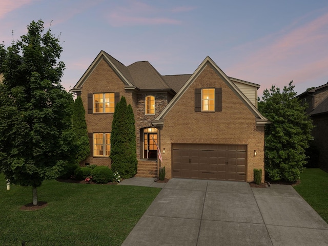 4181 Miles Johnson Pkwy, Spring Hill, TN 37174 - traditional-style house with a garage, brick siding, concrete driveway, and a lawn