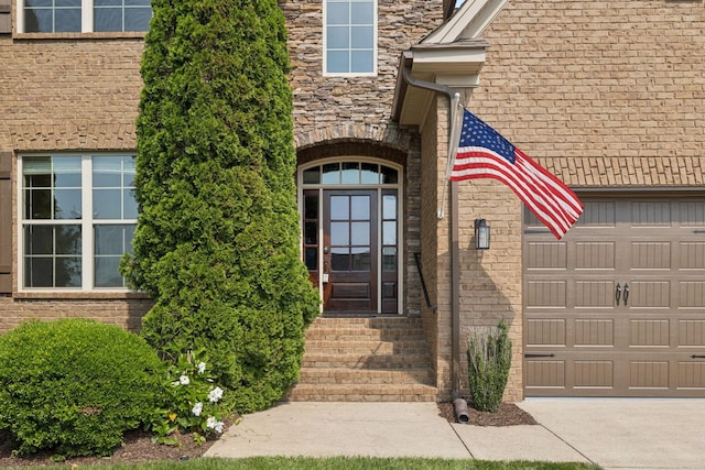 4181 Miles Johnson Pkwy, Spring Hill, TN 37174 - entrance to property featuring stone siding, a garage, and concrete driveway
