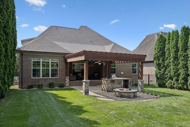 4181 Miles Johnson Pkwy, Spring Hill, TN 37174 - back of property featuring brick siding, a fire pit, a patio area, exterior kitchen, and roof with shingles
