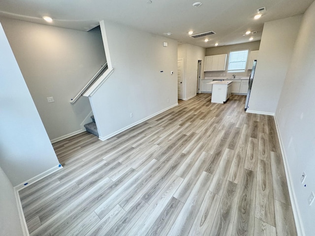 1103 Harper Lndg, Chapel Hill, TN 37034 - unfurnished living room featuring light wood finished floors, stairs, baseboards, and recessed lighting