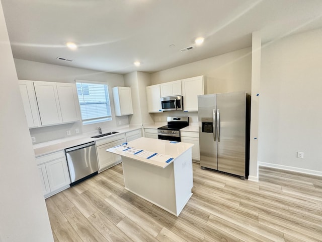 1103 Harper Lndg, Chapel Hill, TN 37034 - kitchen featuring appliances with stainless steel finishes, a sink, white cabinets, light wood-type flooring, and recessed lighting