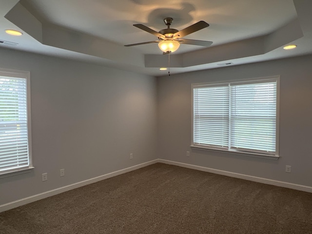 3329 Curie Cir, Christiana, TN 37037 - spare room with a raised ceiling, dark colored carpet, ceiling fan, and recessed lighting