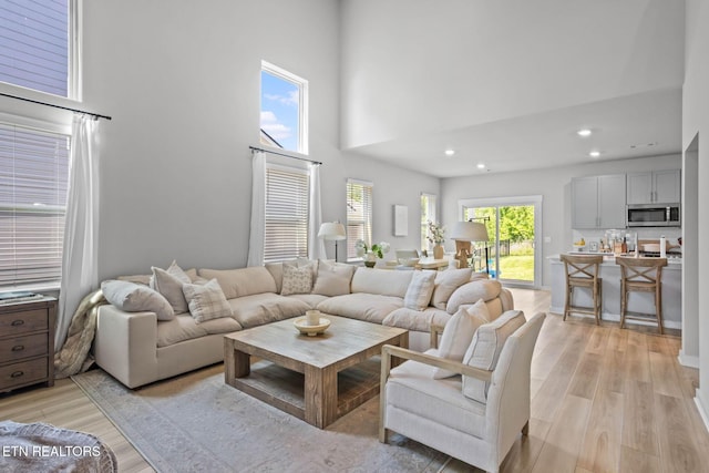 324 Gulfstream Dr, Gallatin, TN 37066 - living area featuring light wood finished floors, a towering ceiling, and recessed lighting