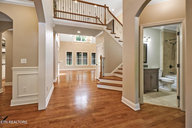 550 Stone Villa Ln, Knoxville, TN 37934 - entrance foyer with arched walkways, a towering ceiling, wood finished floors, stairs, and baseboards