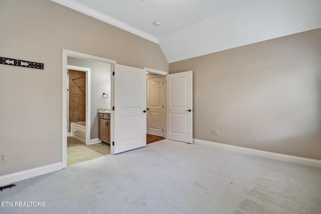 550 Stone Villa Ln, Knoxville, TN 37934 - unfurnished bedroom featuring light colored carpet, baseboards, vaulted ceiling, and ensuite bath