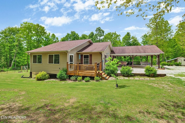 228 Paul Wheeler Ln, Jamestown, TN 38556 - back of property featuring a lawn, a wooden deck, roof with shingles, and a carport