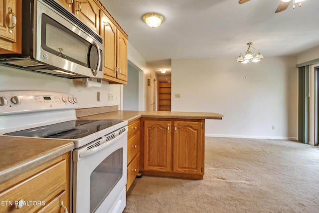 1396 N York Hwy Unit 1396, Jamestown, TN 38556 - kitchen featuring electric stove, stainless steel microwave, light carpet, a peninsula, and brown cabinetry