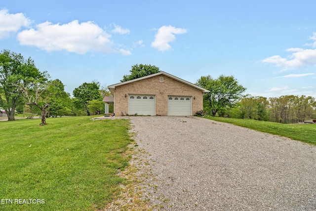 1396 N York Hwy Unit 1396, Jamestown, TN 38556 - view of home's exterior featuring gravel driveway, a lawn, brick siding, and a garage