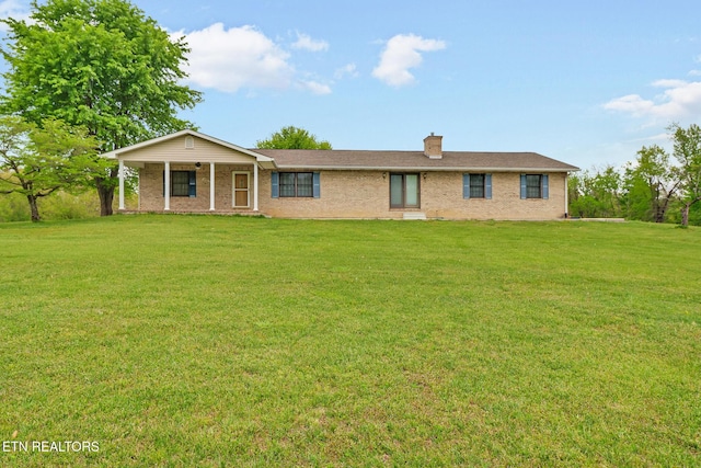 1396 N York Hwy Unit 1396, Jamestown, TN 38556 - view of front facade with a front yard, brick siding, and a chimney