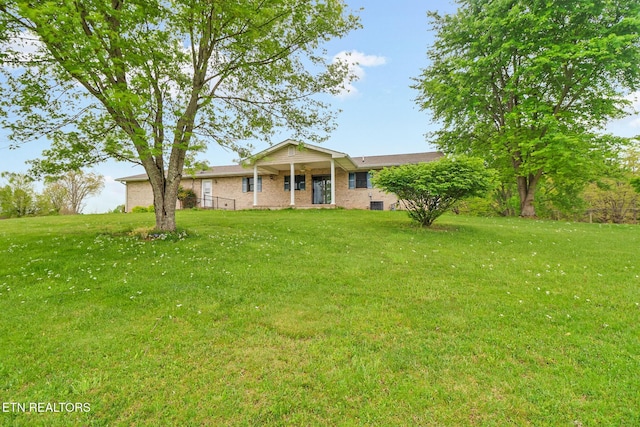 1396 N York Hwy Unit 1396, Jamestown, TN 38556 - ranch-style house with a front yard and brick siding