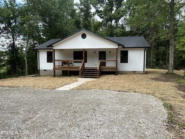 342 N Norris St, Jamestown, TN 38556 - view of front facade featuring crawl space, metal roof, a porch, and view of wooded area