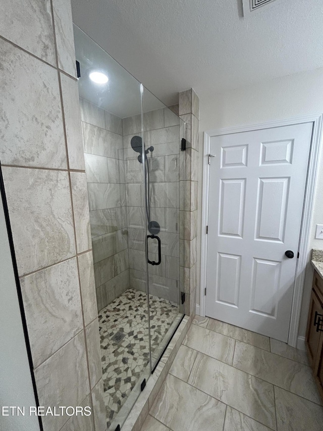 342 N Norris St, Jamestown, TN 38556 - full bathroom with a shower stall, vanity, a textured ceiling, and marble finish flooring