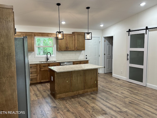 342 N Norris St, Jamestown, TN 38556 - kitchen featuring stainless steel appliances, a sink, a barn door, a kitchen island, and backsplash