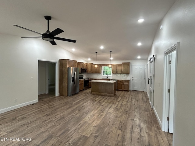 342 N Norris St, Jamestown, TN 38556 - kitchen with appliances with stainless steel finishes, dark wood-style flooring, a center island, open floor plan, and light countertops