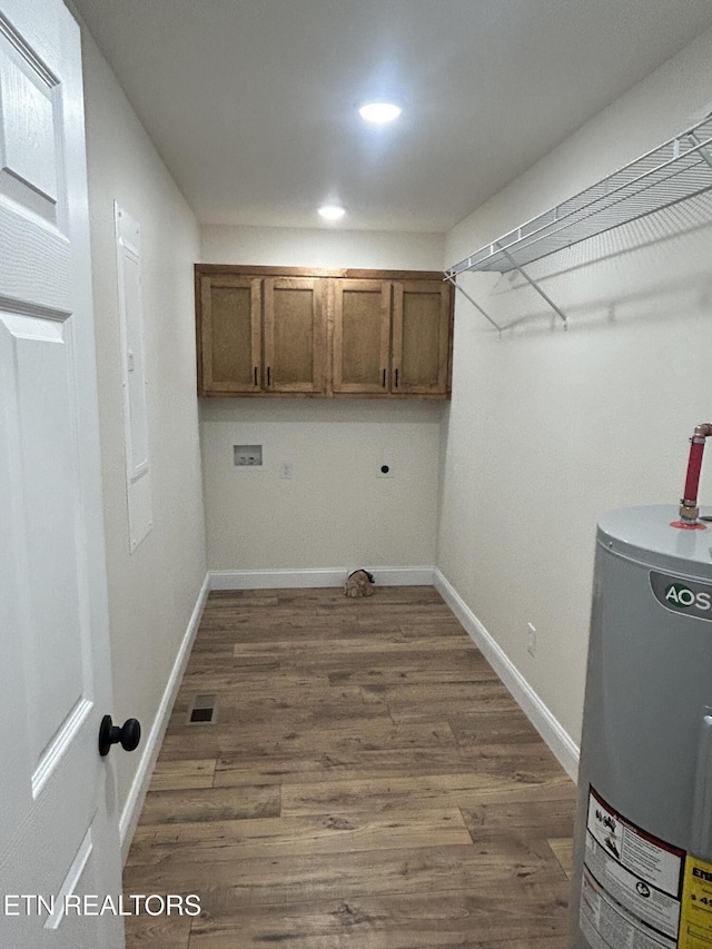 342 N Norris St, Jamestown, TN 38556 - laundry room with cabinet space, water heater, dark wood-style floors, washer hookup, and baseboards