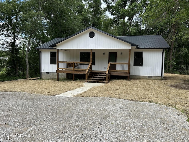 342 N Norris St, Jamestown, TN 38556 - view of front of house with crawl space, metal roof, covered porch, and view of scattered trees