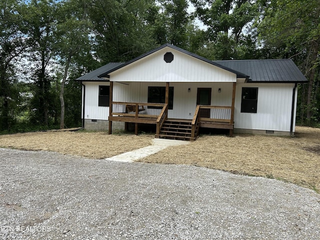 342 N Norris St, Jamestown, TN 38556 - view of front of home featuring crawl space, a porch, metal roof, and view of wooded area