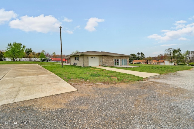 1128 Allardt Hwy, Jamestown, TN 38556 - view of front of home featuring driveway, a front lawn, and an attached garage