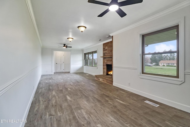 1128 Allardt Hwy, Jamestown, TN 38556 - unfurnished living room featuring crown molding, ceiling fan, wood finished floors, a stone fireplace, and baseboards