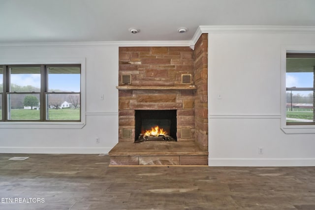 1128 Allardt Hwy, Jamestown, TN 38556 - unfurnished living room with ornamental molding, a stone fireplace, baseboards, and wood finished floors