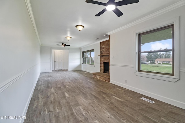 1128 Allardt Hwy, Jamestown, TN 38556 - unfurnished living room with crown molding, a ceiling fan, wood finished floors, a stone fireplace, and baseboards