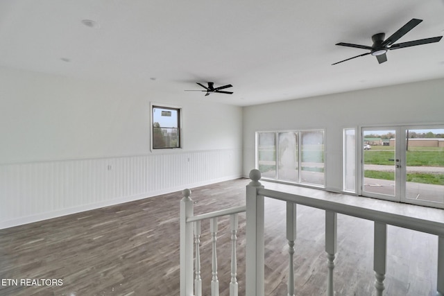 1128 Allardt Hwy, Jamestown, TN 38556 - spare room featuring plenty of natural light, wood finished floors, ceiling fan, and a wainscoted wall