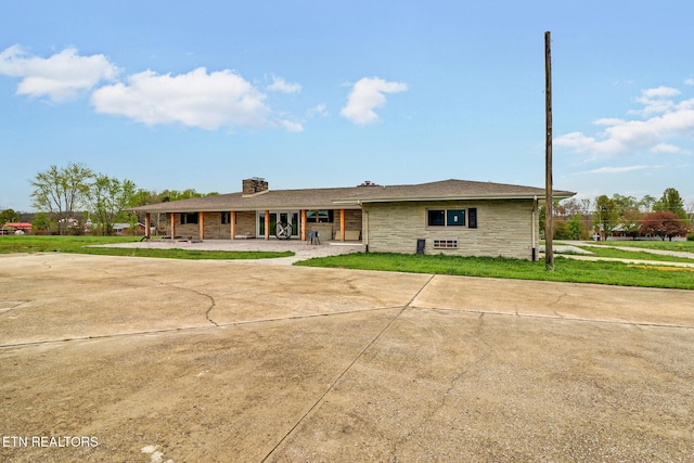 1128 Allardt Hwy, Jamestown, TN 38556 - ranch-style house featuring stone siding, a chimney, driveway, and a front lawn