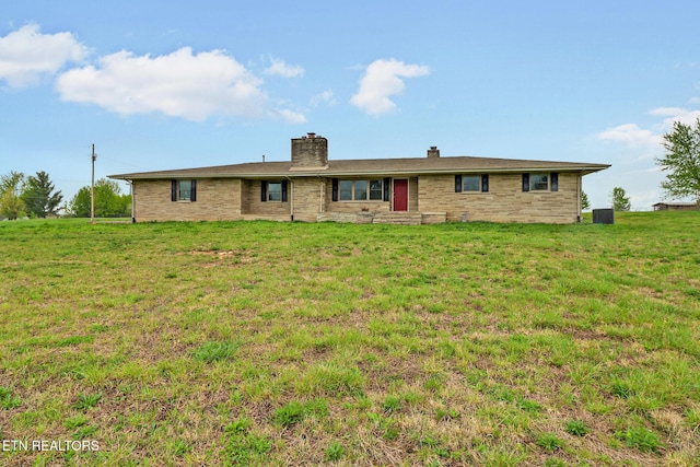 1128 Allardt Hwy, Jamestown, TN 38556 - back of property featuring a chimney, central AC, and a lawn