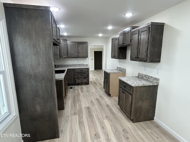 1462 Pennsylvania Ave, Jamestown, TN 38556 - kitchen featuring light wood-style floors, baseboards, dark brown cabinetry, light countertops, and recessed lighting