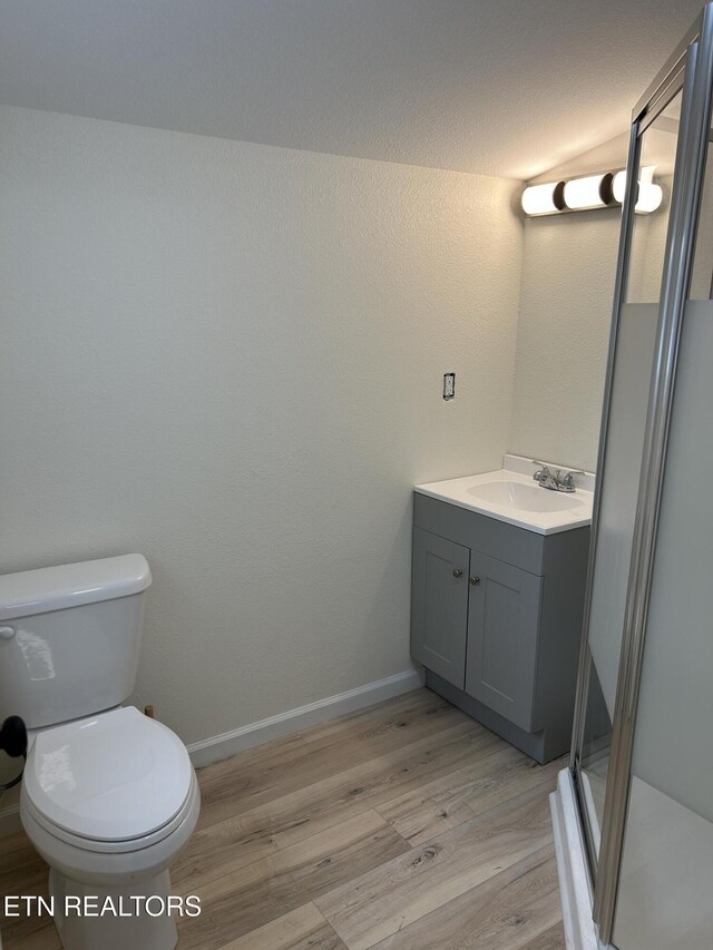 1462 Pennsylvania Ave, Jamestown, TN 38556 - bathroom with vanity, wood finished floors, toilet, a stall shower, and baseboards