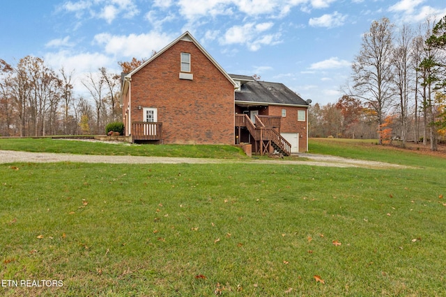 5424 Wilder Rd, Grimsley, TN 38565 - view of home's exterior featuring an attached garage, driveway, a lawn, stairway, and brick siding