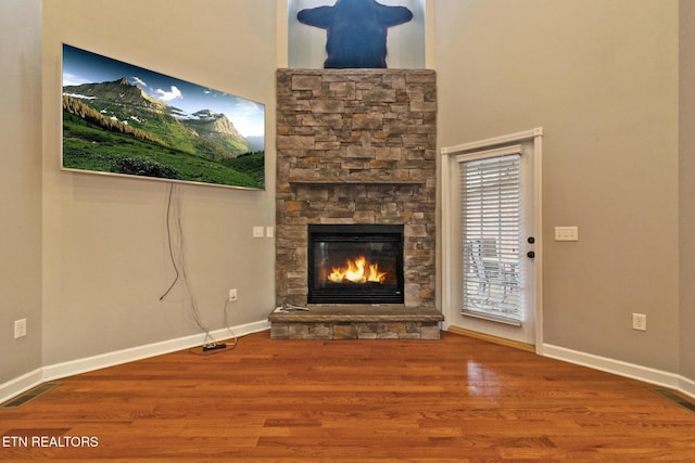 5424 Wilder Rd, Grimsley, TN 38565 - unfurnished living room with a stone fireplace, baseboards, and wood finished floors