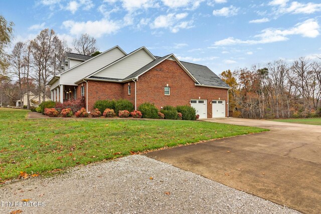 5424 Wilder Rd, Grimsley, TN 38565 - view of property exterior with driveway, a garage, brick siding, and a yard