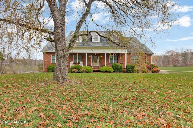 5424 Wilder Rd, Grimsley, TN 38565 - cape cod house with covered porch, a front yard, and brick siding