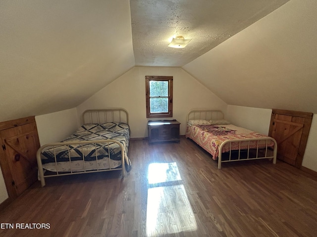 301 Joe Barnett Rd, Jamestown, TN 38556 - bedroom featuring wood finished floors, vaulted ceiling, and a textured ceiling