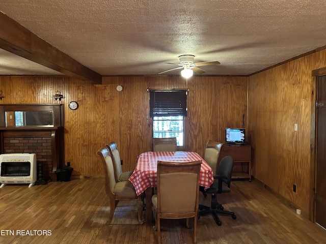 301 Joe Barnett Rd, Jamestown, TN 38556 - dining room with heating unit, wood finished floors, a textured ceiling, a ceiling fan, and wooden walls