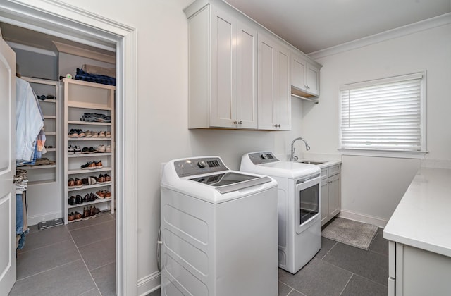 3013 Berry Patch Trl, Rockvale, TN 37153 - laundry area featuring washing machine and dryer, cabinet space, dark tile patterned flooring, ornamental molding, and baseboards
