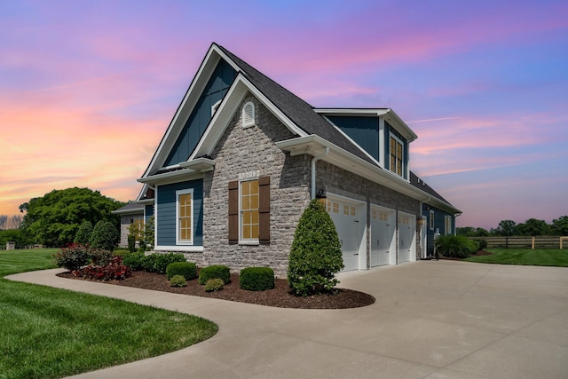 3013 Berry Patch Trl, Rockvale, TN 37153 - property exterior at dusk featuring stone siding, an attached garage, and driveway